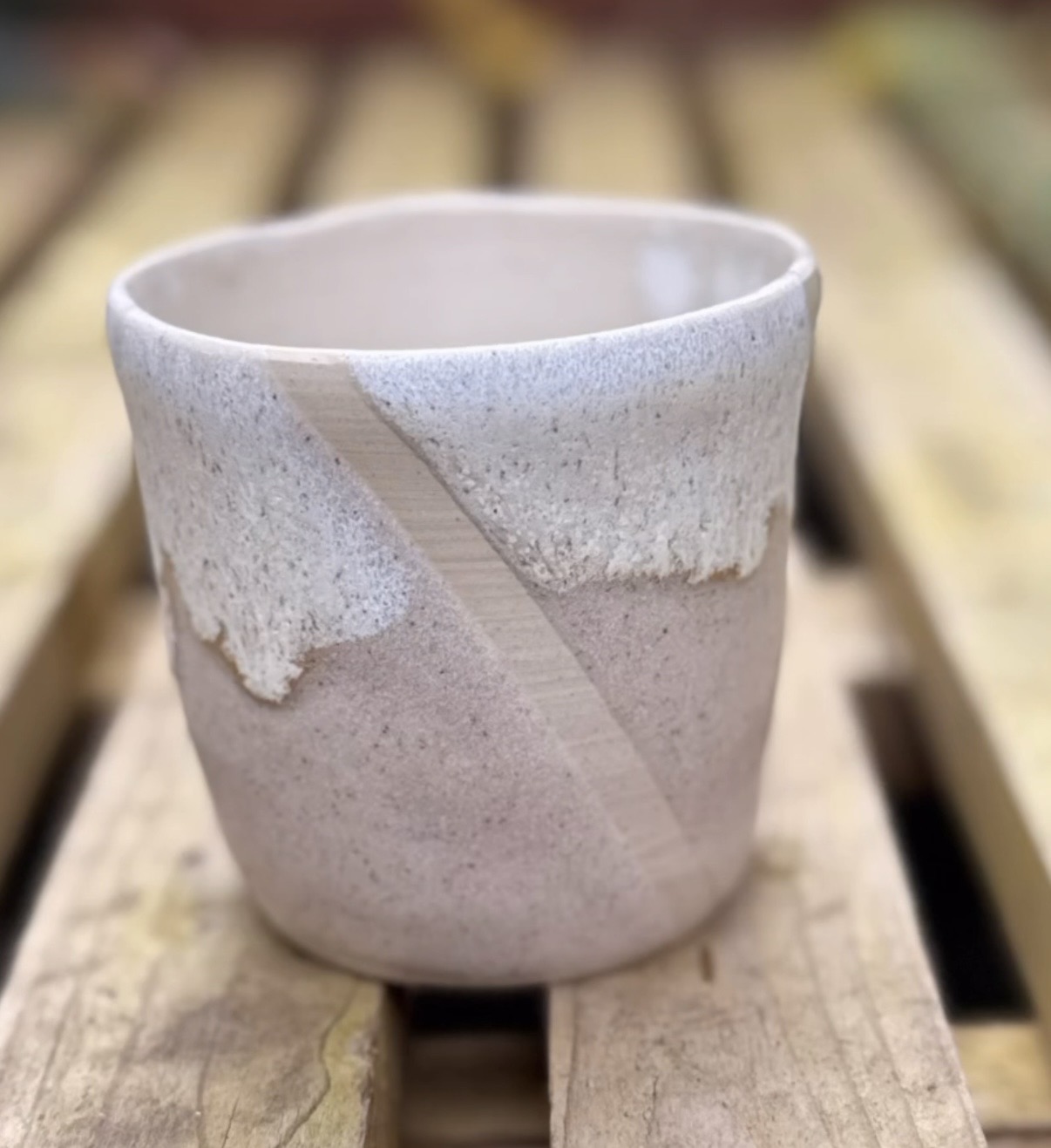 A softly wobbly tumbler with sweeping white glaze
